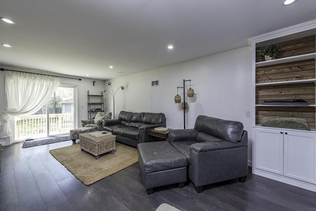living room with recessed lighting and dark wood-type flooring
