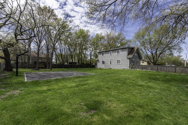 view of yard featuring basketball hoop