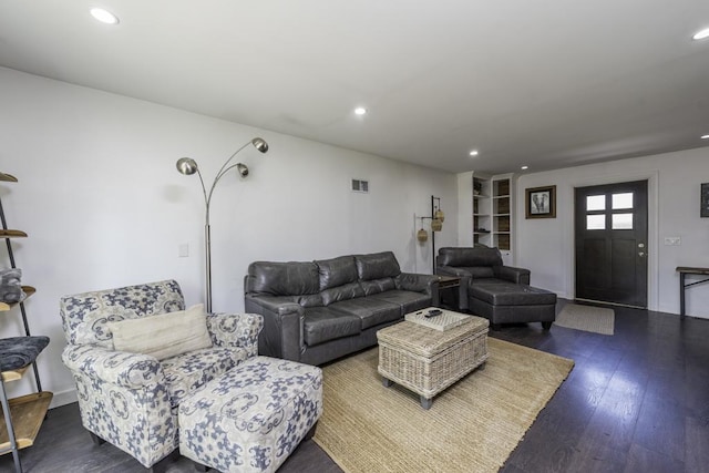 living area featuring wood finished floors, recessed lighting, and built in features