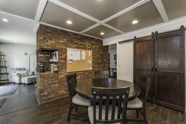 dining room featuring dark wood-style floors, coffered ceiling, a barn door, recessed lighting, and brick wall