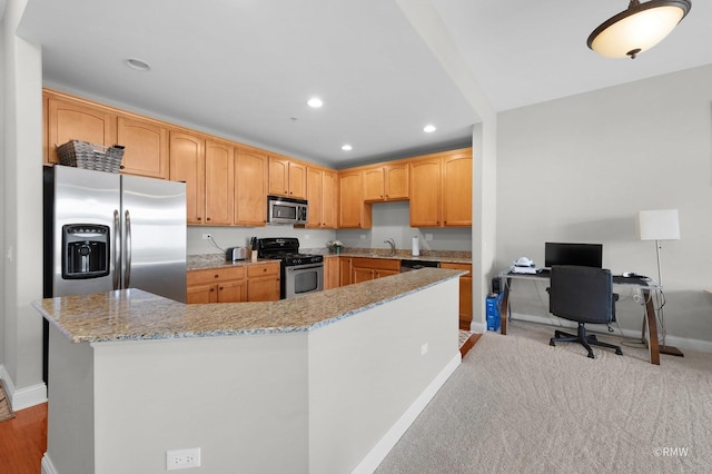 kitchen featuring stainless steel appliances, baseboards, a sink, light stone countertops, and recessed lighting
