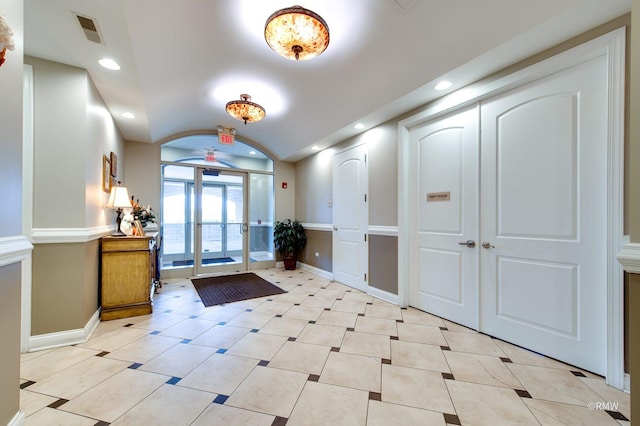 lobby featuring vaulted ceiling and recessed lighting