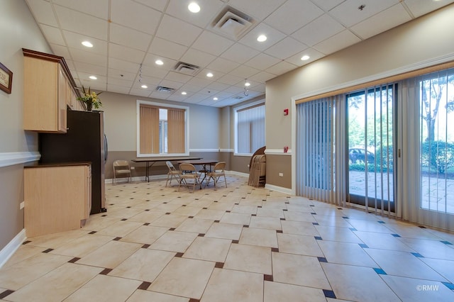 common area with a drop ceiling and recessed lighting