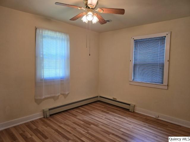 301 N St, Augusta, IL 62311 - unfurnished room featuring wood finished floors, baseboards, and a ceiling fan