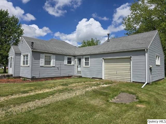 301 N St, Augusta, IL 62311 - view of front of house featuring a garage, a front yard, and a shingled roof