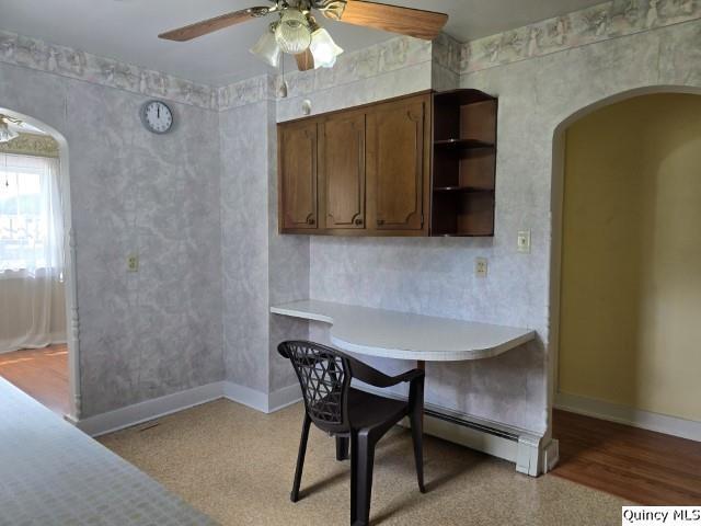 301 N St, Augusta, IL 62311 - dining area featuring a ceiling fan, arched walkways, and baseboards