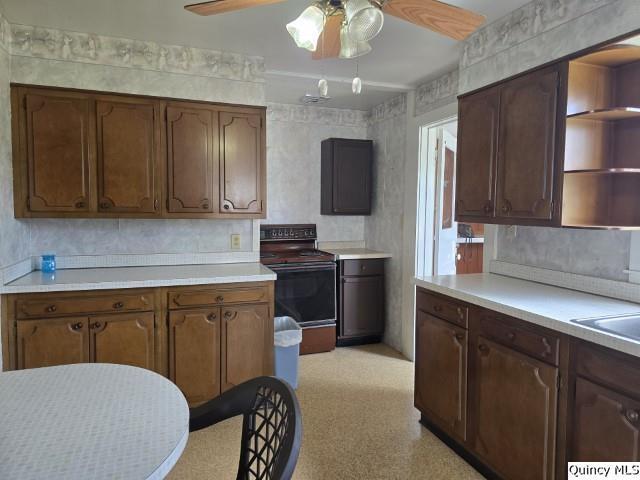 301 N St, Augusta, IL 62311 - kitchen featuring black range with electric stovetop, a ceiling fan, light countertops, and open shelves