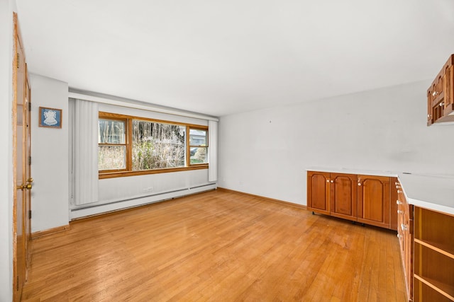 3707 Clarence Ave, Berwyn, IL 60402 - unfurnished room with a baseboard heating unit, light wood-type flooring, and baseboards