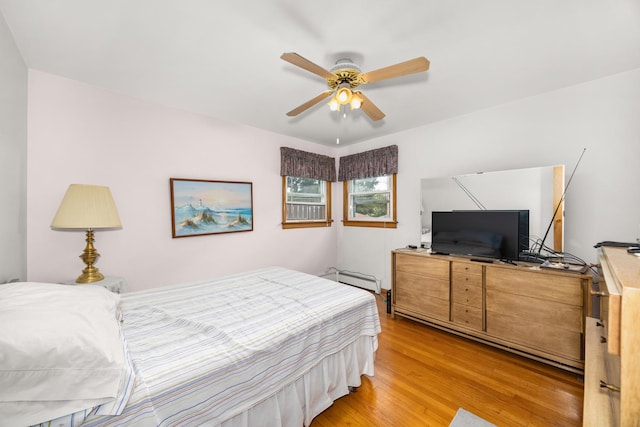 3707 Clarence Ave, Berwyn, IL 60402 - bedroom featuring light wood finished floors, a baseboard heating unit, and a ceiling fan