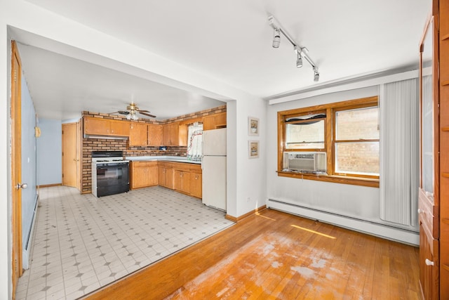 3707 Clarence Ave, Berwyn, IL 60402 - kitchen featuring range with gas stovetop, freestanding refrigerator, baseboard heating, baseboards, and healthy amount of natural light