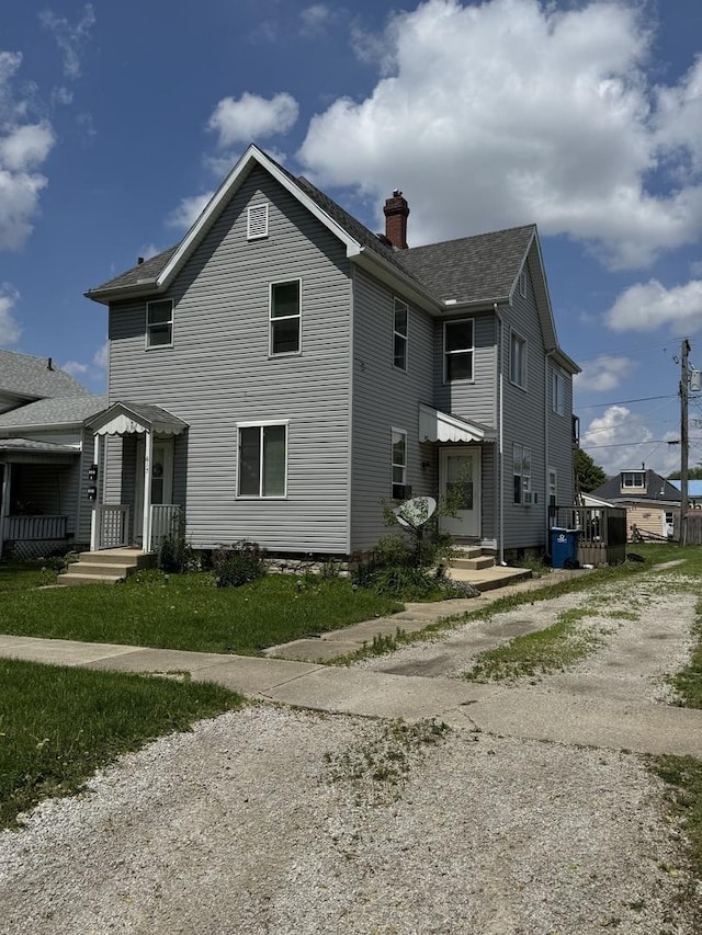 617 W Madison St, Pontiac, IL 61764 - view of front of house with a chimney, driveway, and roof with shingles