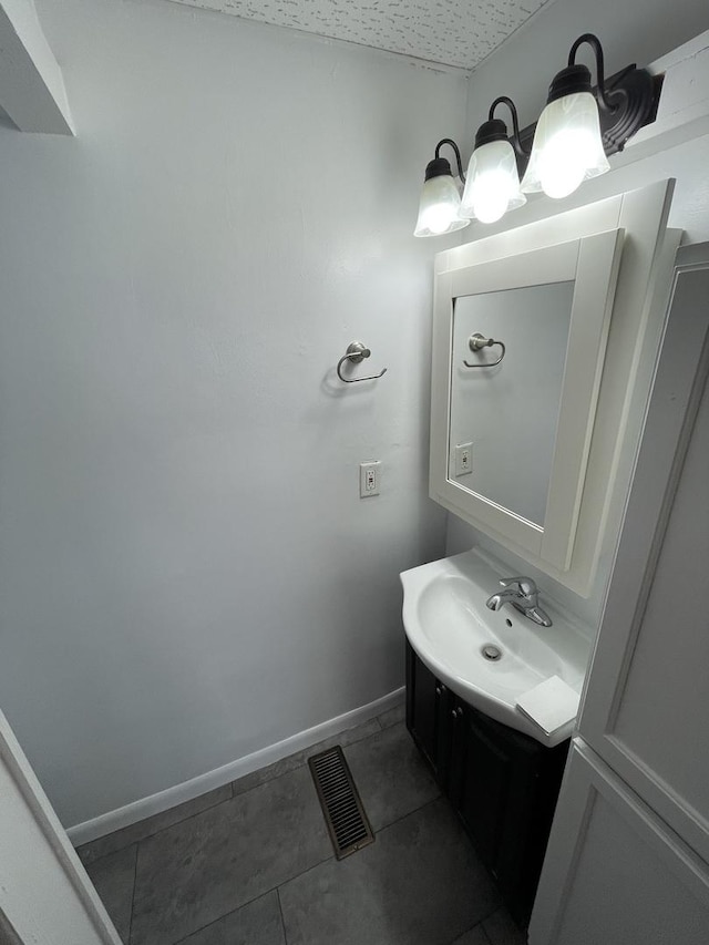 617 W Madison St, Pontiac, IL 61764 - bathroom featuring vanity, tile patterned flooring, and baseboards