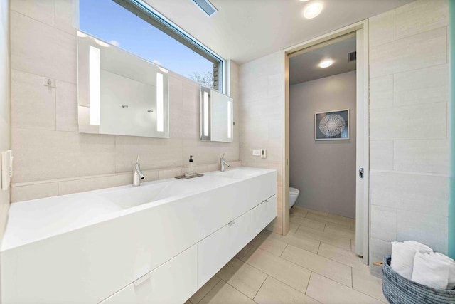 824 Humboldt Ave, Winnetka, IL 60093 - full bath with tile walls, toilet, tile patterned flooring, and double vanity