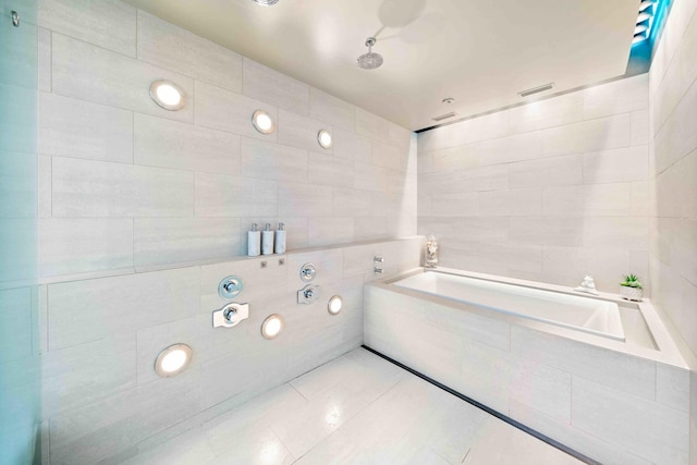 824 Humboldt Ave, Winnetka, IL 60093 - bathroom featuring tile walls, a garden tub, tile patterned flooring, and tiled shower