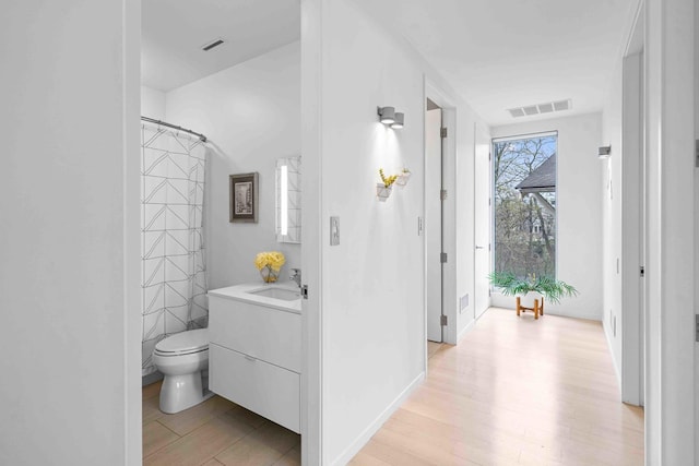 824 Humboldt Ave, Winnetka, IL 60093 - full bath with toilet, vanity, wood finished floors, and curtained shower