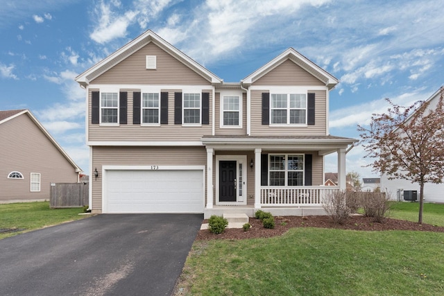 173 Willowwood Dr N, Oswego, IL 60543 - view of front of property with an attached garage, a porch, and driveway