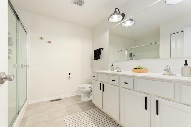 173 Willowwood Dr N, Oswego, IL 60543 - bathroom with a shower stall, double vanity, toilet, and baseboards
