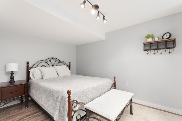 173 Willowwood Dr N, Oswego, IL 60543 - bedroom featuring baseboards, wood finished floors, and track lighting