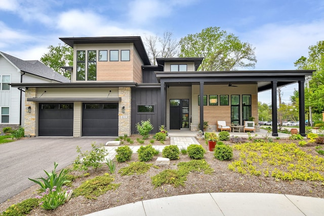 view of front of house featuring a porch, board and batten siding, a garage, and driveway