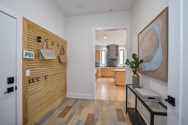 hallway with light wood-style flooring and baseboards
