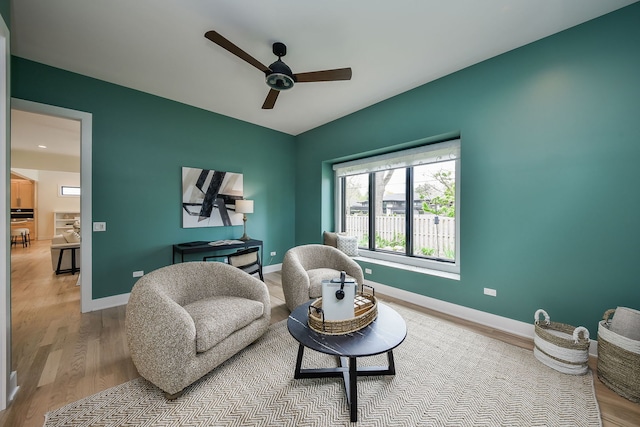 living area featuring ceiling fan, wood finished floors, and baseboards