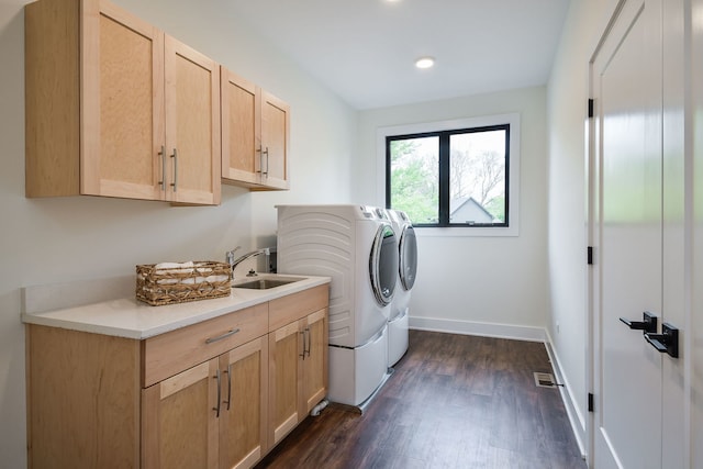 washroom featuring cabinet space, independent washer and dryer, dark wood-type flooring, baseboards, and recessed lighting