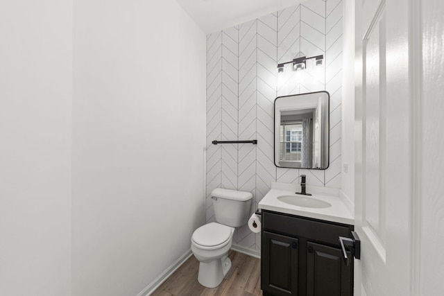 4216 Drexel Ave, Aurora, IL 60504 - half bath with toilet, wood finished floors, vanity, tile walls, and baseboards