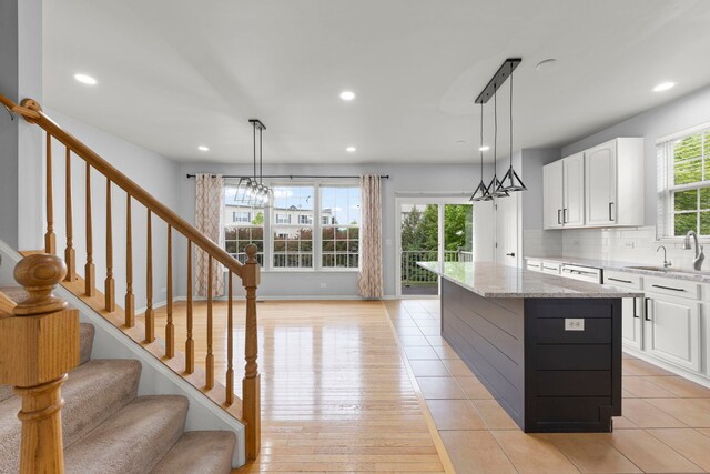 4216 Drexel Ave, Aurora, IL 60504 - kitchen featuring a sink, a kitchen island, white cabinets, recessed lighting, and a chandelier