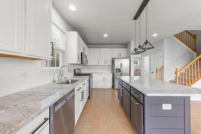 4216 Drexel Ave, Aurora, IL 60504 - kitchen with stainless steel appliances, a sink, white cabinetry, backsplash, and recessed lighting