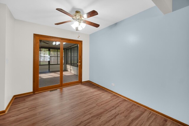 588 Renee Dr, South Elgin, IL 60177 - spare room featuring wood finished floors, baseboards, and a ceiling fan