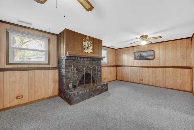 588 Renee Dr, South Elgin, IL 60177 - unfurnished living room with ceiling fan, wood walls, plenty of natural light, and carpet flooring