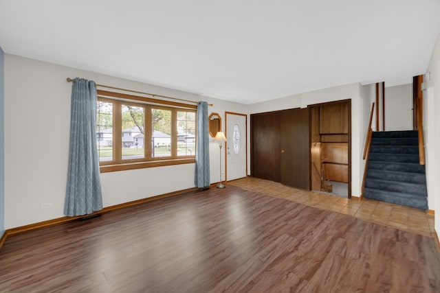 588 Renee Dr, South Elgin, IL 60177 - unfurnished living room featuring wood finished floors, stairs, and baseboards
