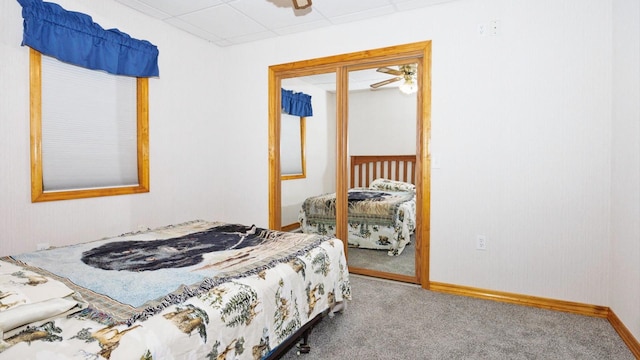 bedroom with carpet, a closet, and baseboards