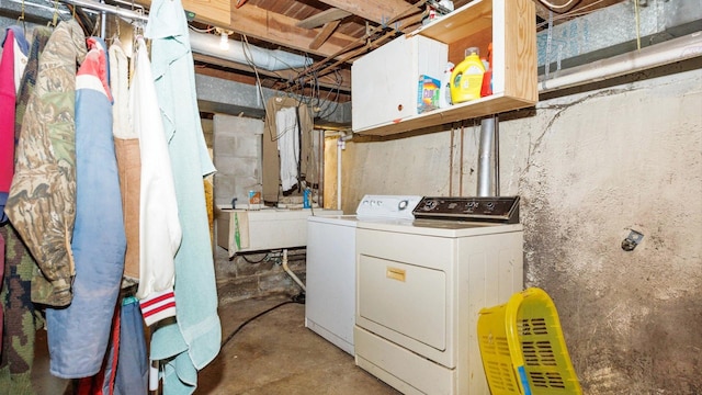 laundry area featuring separate washer and dryer and a sink