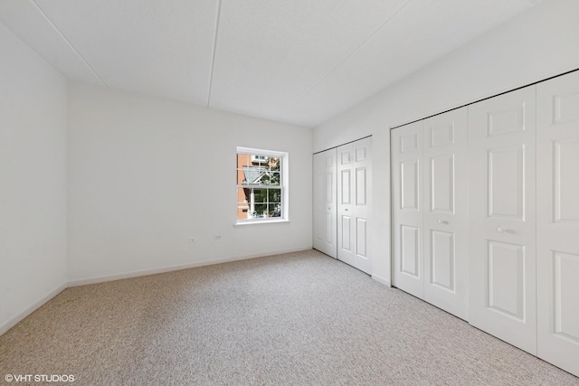200 N Addison Ave Unit 204, Elmhurst, IL 60126 - unfurnished bedroom with two closets, carpet, and baseboards