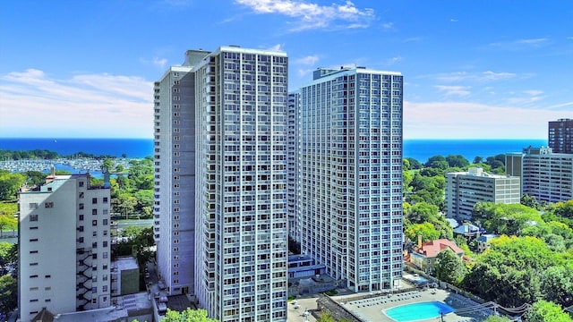 view of building exterior featuring a water view and a city view
