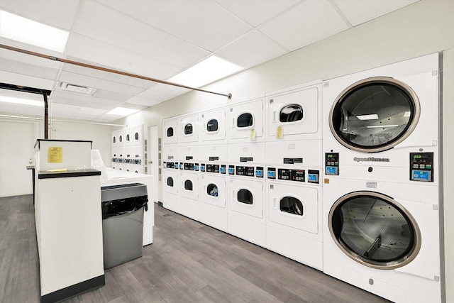 communal laundry room featuring stacked washer / dryer, separate washer and dryer, and wood finished floors