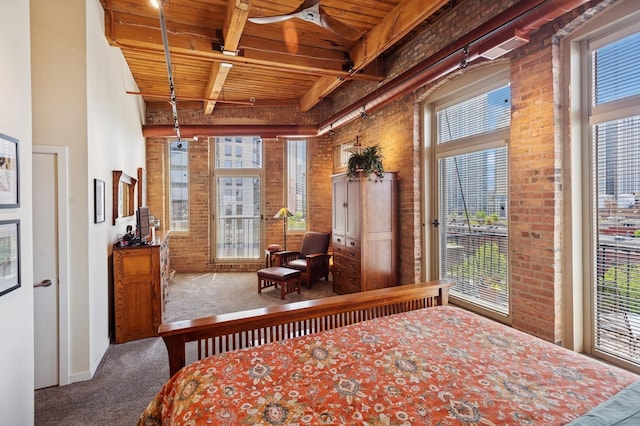 bedroom featuring carpet, wood ceiling, beam ceiling, multiple windows, and baseboards