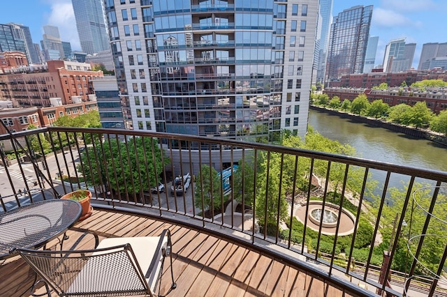 balcony with a skyline view and a water view