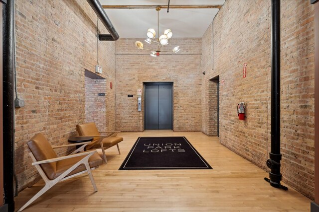 1327 W Washington Blvd Unit 5G-H, Chicago, IL 60607 - building lobby featuring brick wall and a towering ceiling