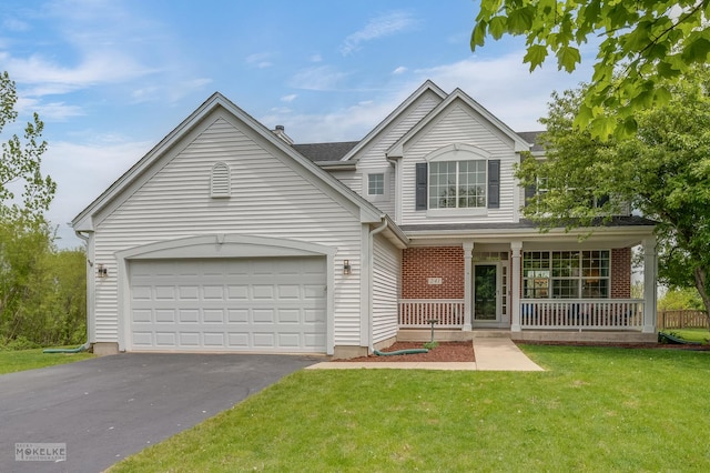241 Morgan Valley Dr, Oswego, IL 60543 - traditional-style home with covered porch, asphalt driveway, a front yard, and a garage