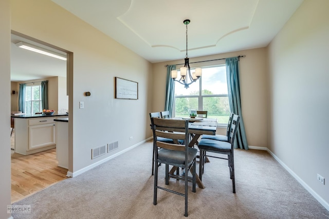 241 Morgan Valley Dr, Oswego, IL 60543 - dining space featuring light colored carpet, a chandelier, and baseboards