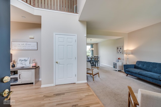 241 Morgan Valley Dr, Oswego, IL 60543 - living area featuring baseboards, a chandelier, and wood finished floors