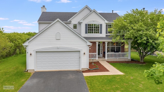 241 Morgan Valley Dr, Oswego, IL 60543 - traditional-style house with covered porch, asphalt driveway, a front yard, and a garage