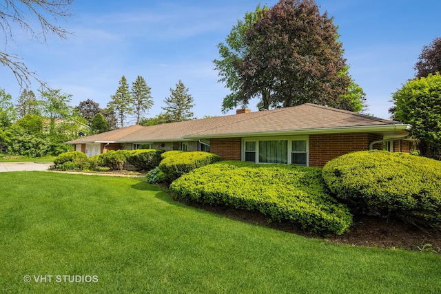 1715 W Main St, Sleepy Hollow, IL 60118 - view of front of house with a front yard, a chimney, and brick siding