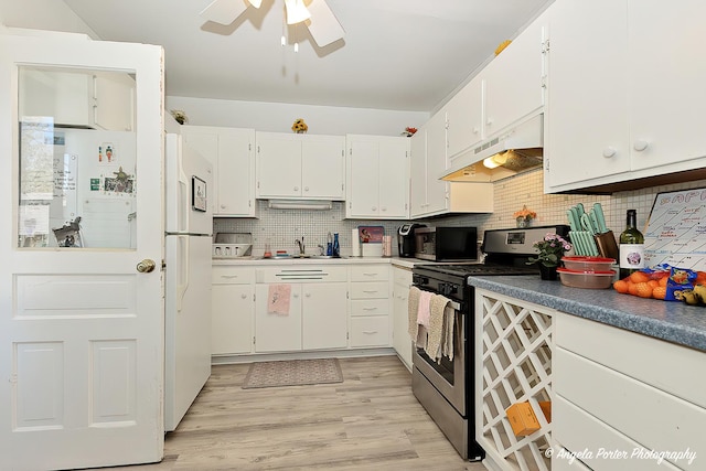 10208 N Main St, Richmond, IL 60071 - kitchen with stainless steel gas stove, under cabinet range hood, a ceiling fan, tasteful backsplash, and white cabinets