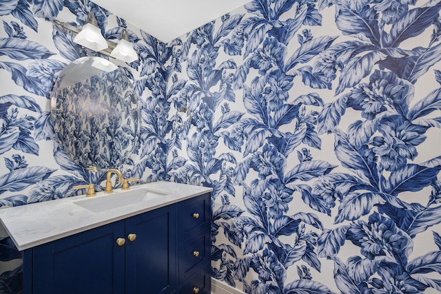 bathroom featuring wallpapered walls and vanity