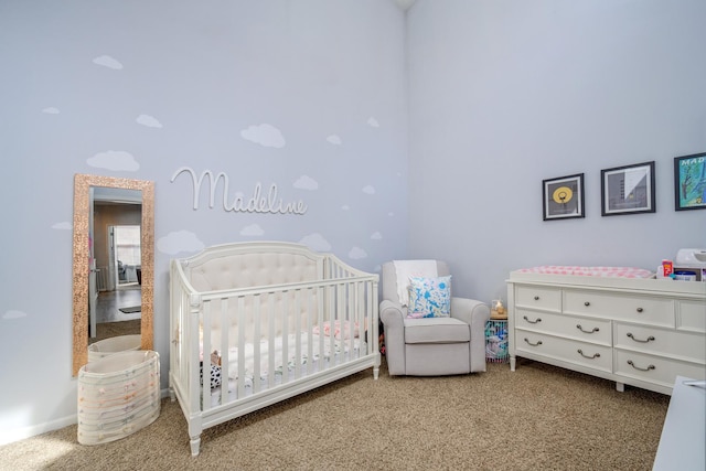 carpeted bedroom featuring a crib