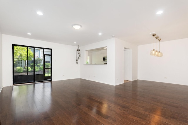 empty room with wood finished floors, recessed lighting, and baseboards