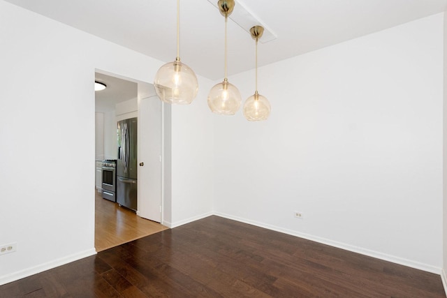 unfurnished dining area with dark wood-style floors and baseboards
